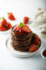 Homemade chocolate pancakes with strawberry sauce