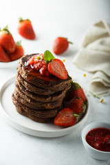 Homemade chocolate pancakes with strawberry sauce