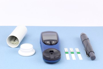 Glucometer. A device for measuring blood sugar levels. Test strips on a uniform background.