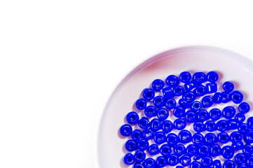 .Round blue beads for making jewelry shot large on a white background