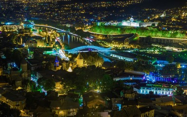 Night view of Tbilisi old town, Peace Bridge over the Kura River and Presidential Administration Palace. Tbilisi is capital and largest city of Georgia.