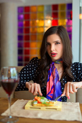 beautiful young woman eats in a restaurant