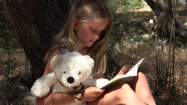 Child Reading Book by Tree Schoolgirl Enjoying Outdoor Kid Studying in Nature
