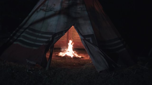 CampFire in a indian tent, teepee at night with moonlight - Smooth moving forward