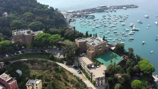 Orbital aerial shot of Grand Hotel dei Castelli in Sestri Levante, Liguria, Italy - Sunny summer day 4k