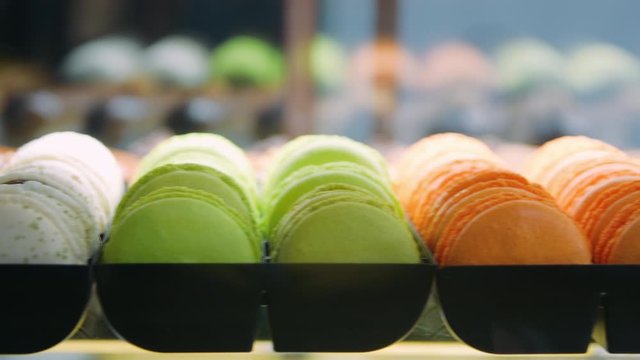 Closeup sweet bakery lying on glass case. Close up colorful macaron on showcase.