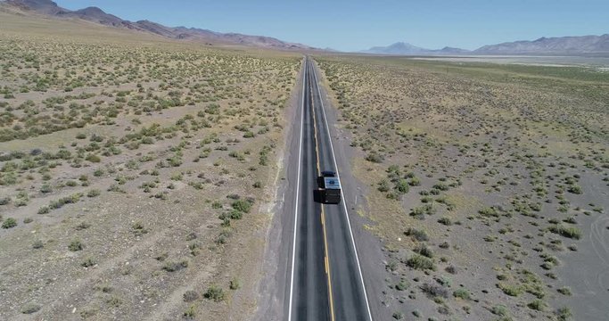 Trucks driving along a road in the Nevada desert