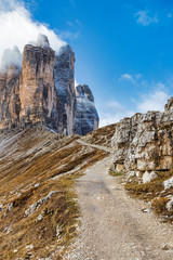 Picturesque hiking trail in Dolomite alps with a view of famous Tre Cime mountains