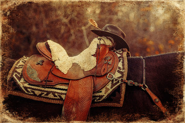 detail of beautiful horse saddl with natural textures and a hat. Old photo effect.
