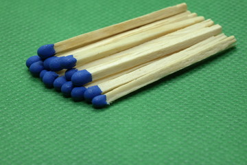 wooden matchsticks on green background