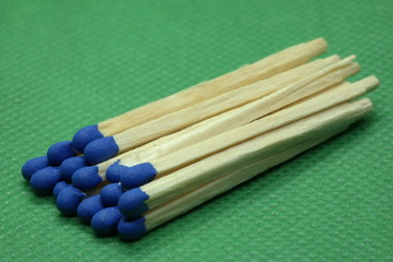 wooden matchsticks on green background