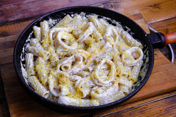 squid pasta composition on a wooden background