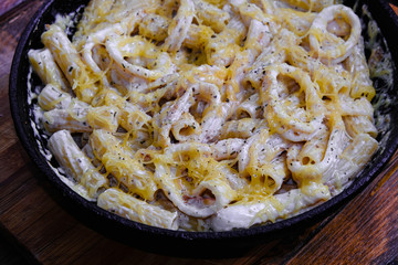 squid pasta composition on a wooden background