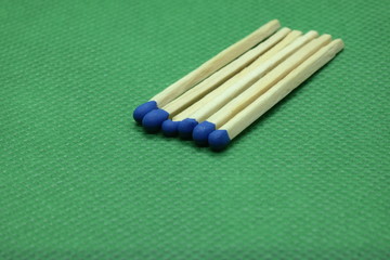 wooden matchsticks on green background
