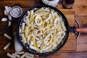 squid pasta composition on a wooden background