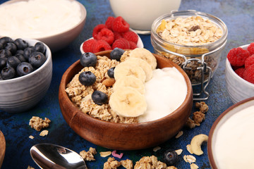 Tasty homemade granola served on table. Healthy breakfast with a bowl of oatmeal with banana, blueberries, strawberries and healthy food for Breakfast