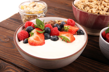 Tasty homemade granola served on table. Healthy breakfast with a bowl of oatmeal with banana, blueberries, strawberries and healthy food for Breakfast