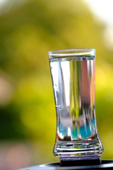 glass of water on green background