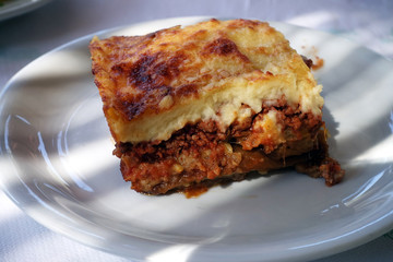 moussaka with aubergine on a dish. traditional greek meal on a table