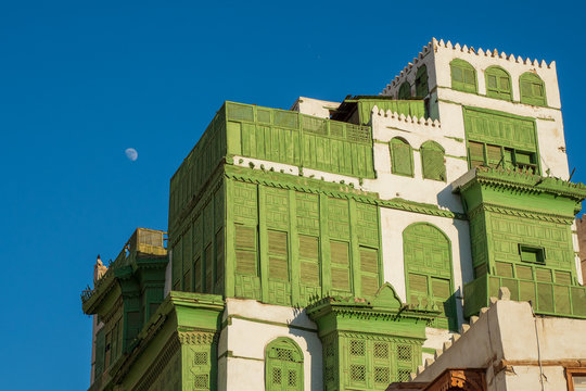 View of the famous greenish Noorwali coral town house at the Souk al Alawi Street in the historic city center of Al Balad, Jeddah, Saudi Arabia