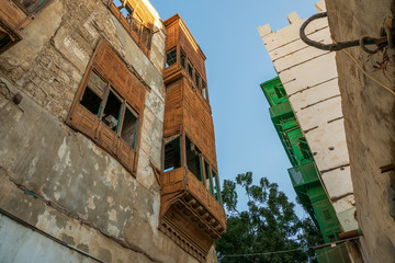 Fototapeta na wymiar Exterior view of dilapidated traditional residential buildings at the historic district, Al Balad, old city of Jeddah, Saudi Arabia