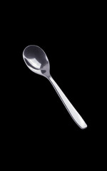 Teaspoon on black isolated background