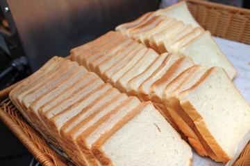 Lots of fresh bread in a basket on a table