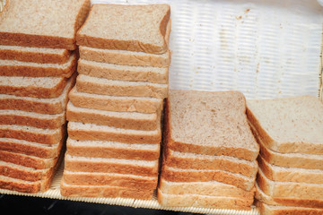 Lots of fresh bread in a basket on a table