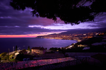 Panoramic night view of Sanremo and the Ligurian coast (Italy, Mediterranean sea). This town is famous in the world for flowers cultivation and for the annual Italian song festival.