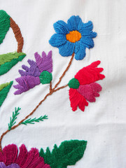 embroidered flowers on a white background, ethnic fabric decor, Ukrainian folk embroidery