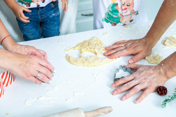 Obraz na płótnie Canvas Family cooking homemade cakes. Moms and children hands holding cookie cutters. Family Cooking flat lay. Sweet home. Happiness concept. 