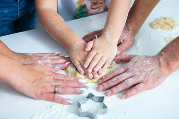 Family cooking homemade cakes. Moms and children hands holding cookie cutters. Family Cooking flat lay. Sweet home. Happiness concept. 