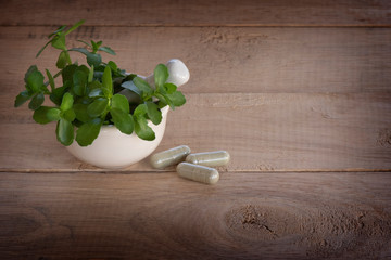 Alternative medicine herb , mortar, laboratory glassware, on a wooden background.