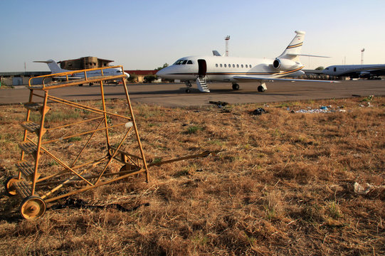 Business Jet surrounded by poverty