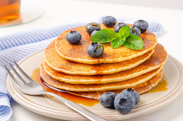 Stack of pancakes with fresh blueberry and caramel syrup