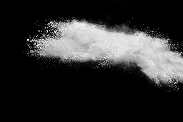 White powder explosion isolated on black background.