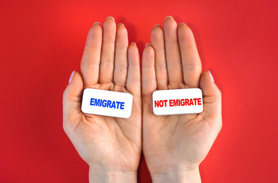 Expat and emigration idea. Emigrate or not. Concept with blocks and text in a hands.
