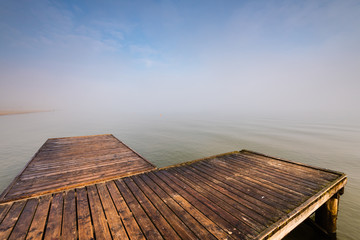 Wooden jetty by the sea during the morning fog. Baltic Sea, Sopot Poland