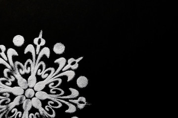 extreme close up of cropped white rangoli design on black background. diwali concept