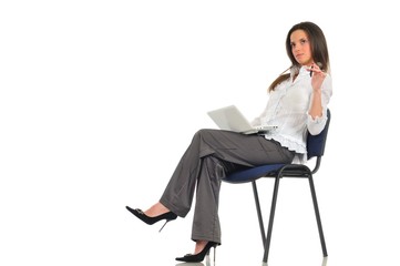 Woman sitting on chair with laptop on lap