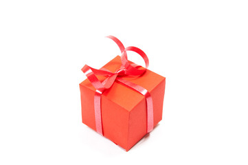 red gift box with red ribbon on white background