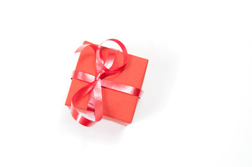 red gift box with red ribbon on white background