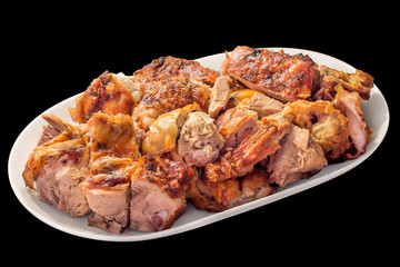 Plateful of Freshly Spit Roasted Pork Thigh Crunchy Meat Slices Served on Oblong Porcelain Tray Isolated on Black Background