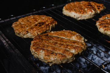 chicken burger composition on a bbq grill