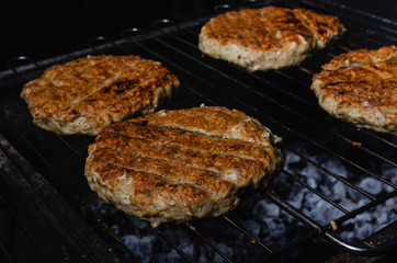 chicken burger composition on a bbq grill