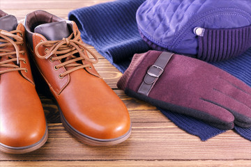 Men's stylish winter clothes on wooden table. winter fashion concept.