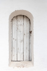  old wooden white rounded top door with padlocked
