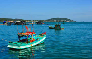 Naklejka na ściany i meble Fishing boats on the blue sea