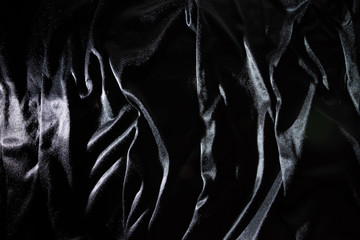 Black silk fabric background abstract Smooth and elegant background use with copy space, close-up...