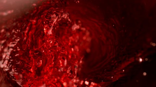 Super slow motion of pouring red wine in twister shape. Filmed on high speed cinema camera, 1000 fps.